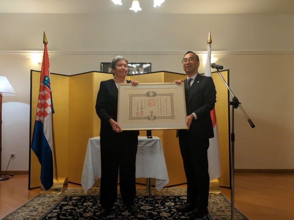 confer decoration on Melita Racki